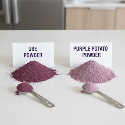 Side by side comparison of vibrant purple ube powder and lighter purple potato powder with measuring spoons on white counter Image